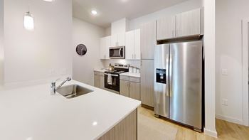 Bright kitchen with white countertops and stainless appliances